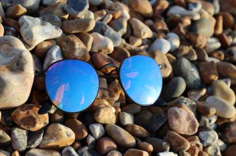 black farmed sunglasses on rocks