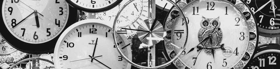 black and white photo of clocks